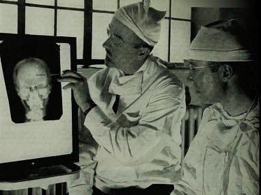 Dr. Walter Freeman (left) and Dr. James W. Watts studying an x-ray before performing a lobotomy.